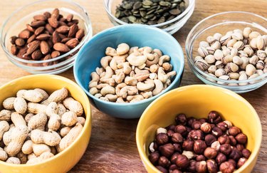Assortment of mixed nuts on wood table background