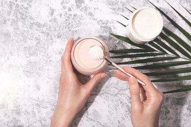 Woman hands, protein powder and smoothie.