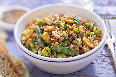 Quinoa, spelt, peanuts, almond, pistachios salad with soy and ginger dressing