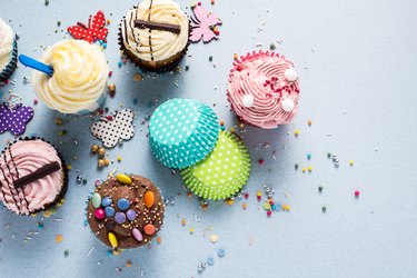 Vibrant cupcakes on blue background, party food concept