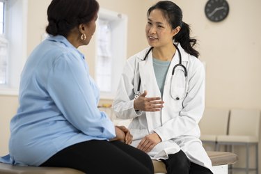 A doctor talking to a senior woman with prediabetes