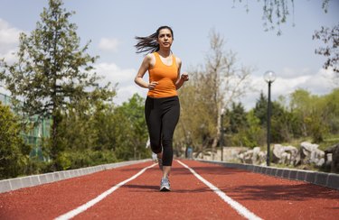 Healthy young sports woman jogging outdoors