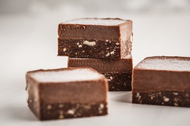 Chocolate fudge bars on white background. Raw vegan dessert.