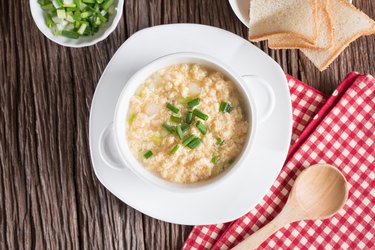 Egg drop soup in white bowl. Top view.