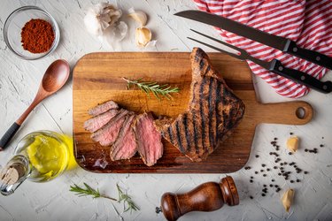 sliced tri tip seak marinated with santa maria sauce  on wooden cutting board