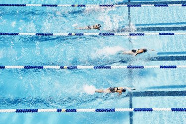 Competitive swimmers racing in outdoor pool