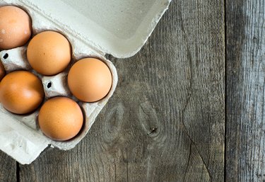 Close-Up Of Eggs In Carton On Table