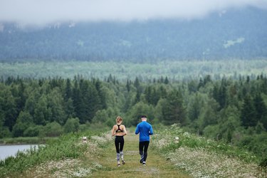 Man and woman running far away the wild road