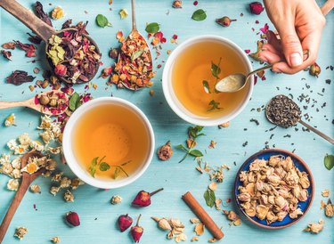 Two cups of healthy herbal tea with mint, cinnamon, dried