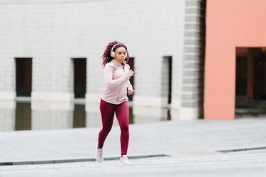 Sports woman running up stairs as training routine