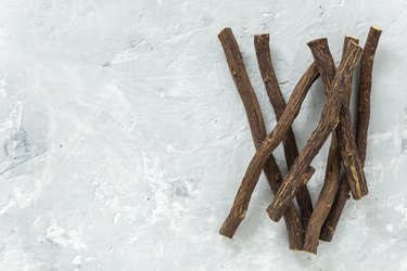 Powder and licorice root on the table - Glycyrrhiza glabra.