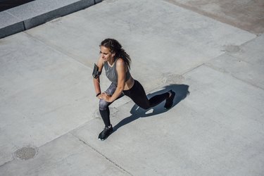 Young athletic woman stretching outdoors