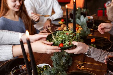 Woman eating vegetables at a holiday dinner