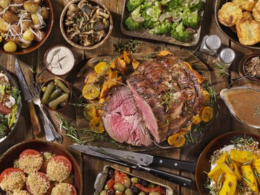 Slow cooker roast beef on table with festive side dishes