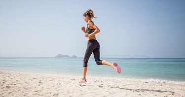 Sporty woman running on the beach
