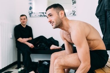 Men on benches in changing room