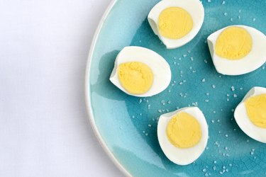 closeup top view sliced eggs with salt