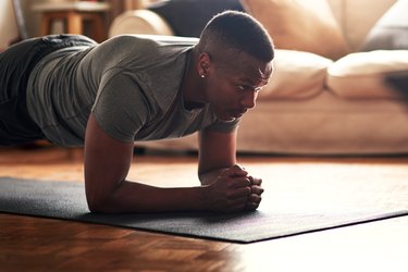 man doing a plank exercise at home