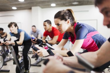 Group of people practicing sport in a gym.