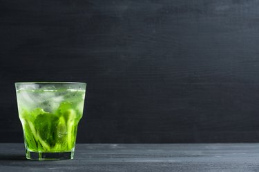 Green cocktail with kiwi slices