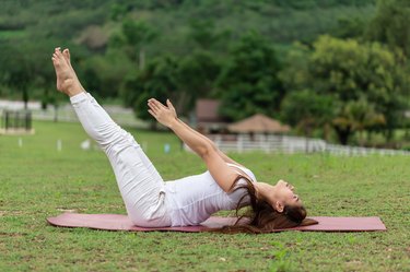 Woman practice yoga Dead Body pose or Uttana Padasana pose