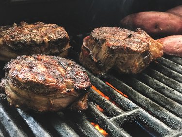 Grilled Elk Bacon Wrapped Tenderloin being cooked on gass grill in Springfield MO