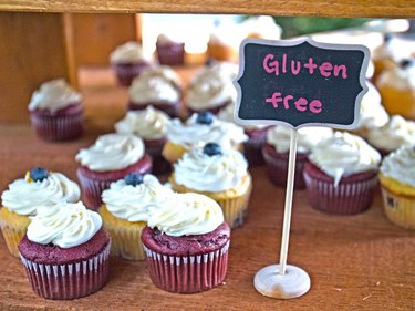A display of cupcakes with a sign that reads gluten free
