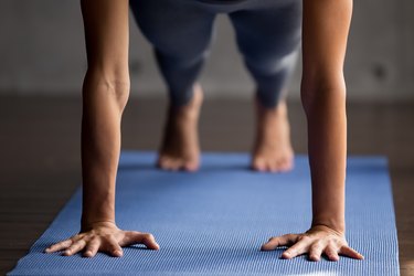 Sporty woman doing Plank pose, close up view