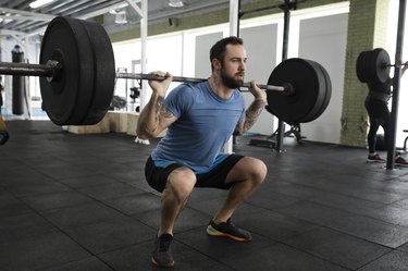 Man squatting with proper form.