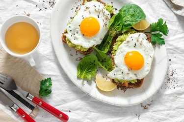 Top view healthy avocado toasts breakfast lunch fried eggs cup tea healthy breakfast