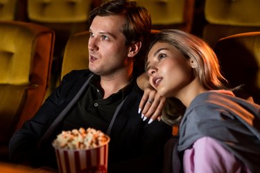 Caucasian lover watching a movie in the cinema
