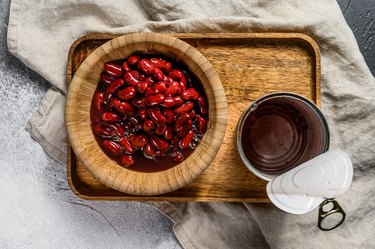 Red canned beans in an aluminum can. Gray background. Top view