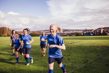 Healthy teenage girls with normal heart rates on sports field