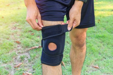 man wearing knee sleeve in the park