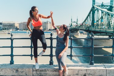 Sports women doing high five after workout