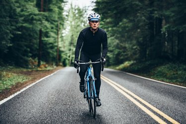 Person on a bike outdoors doing a HIIT cycling workout