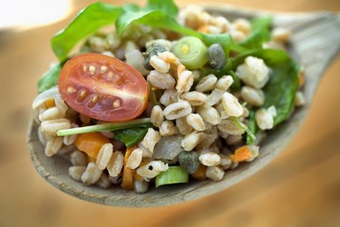 Farro salad on spoon for cheap protein foods