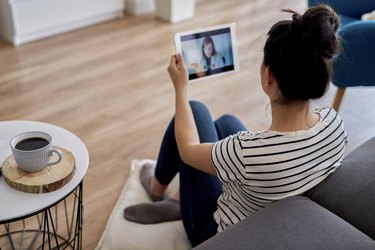 Young woman having a video conference with her doctor