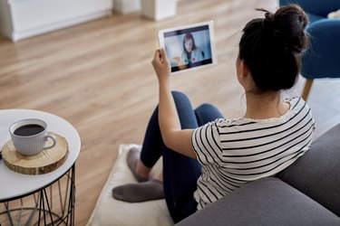 Young woman having a telehealth visit with her doctor from home