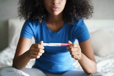 Young Woman With Pregnancy Test At Home