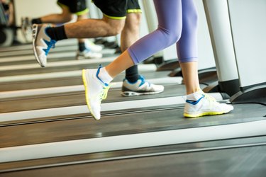 Couple exercising on treadmills in the gym