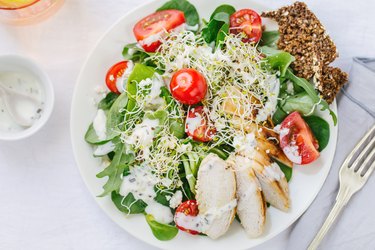 Top view of fresh summer salad on plate on table