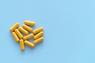women's multivitamins capsules on a blue background that are different than men's vitamins