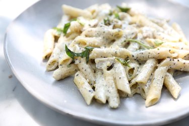 Penne pasta with white sauce and truffle , italian food