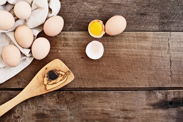 Fresh raw egg in shell on wooden table