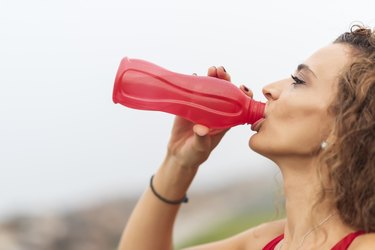 woman drinks water at training