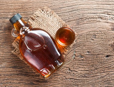 maple syrup in glass bottle on wooden table