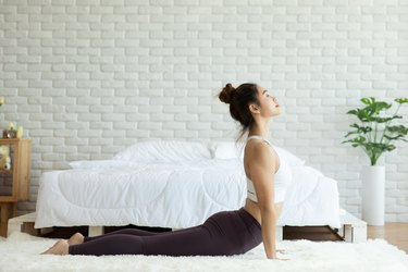Attractive Asian woman practice yoga Cobra pose to meditation in bedroom after wake up in the morning Feeling so comfortable and relax,Healthcare Concept