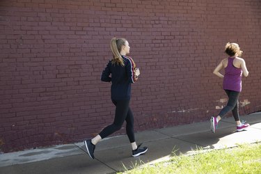 Women running on urban sidewalk