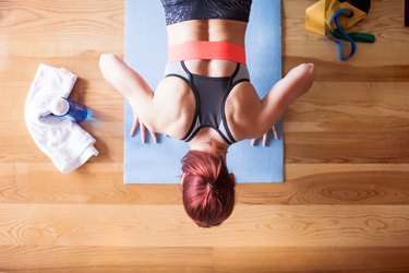 Young woman doing exercise at home.